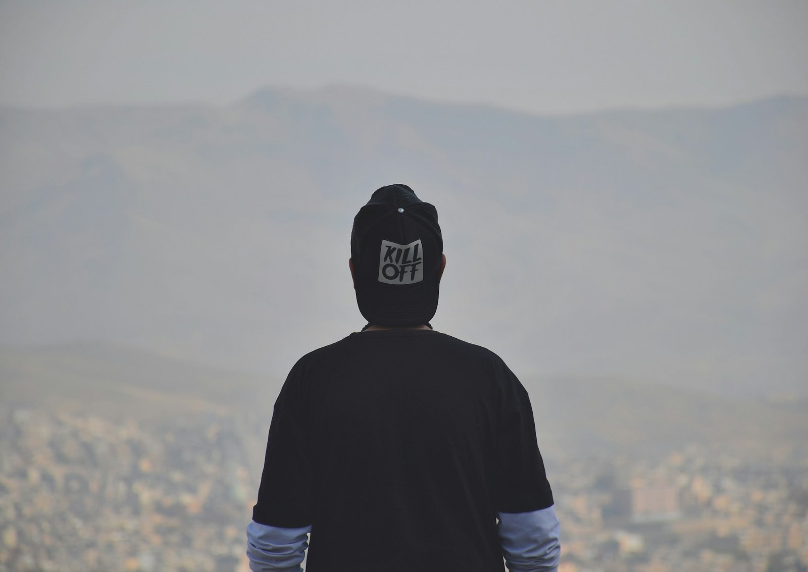 homem de costas vestindo boné preto